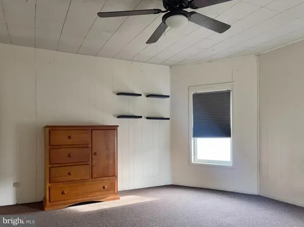 a view of a livingroom with a ceiling fan and window
