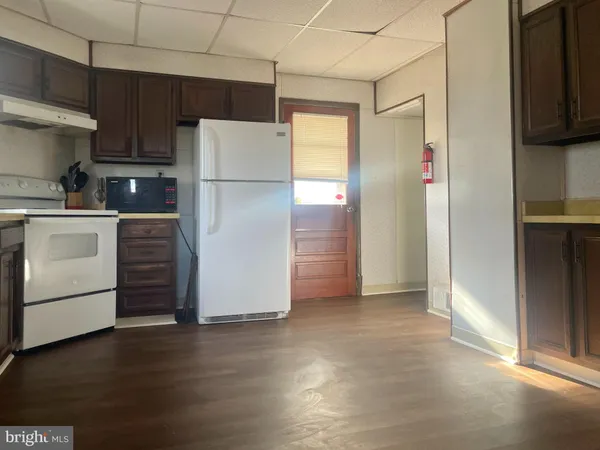 a kitchen with a refrigerator and a stove