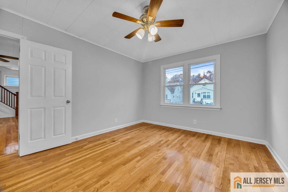 34 Maple Avenue Edison, NJ 08837 - Photo 11 of 20 wooden floor in an empty room with a window