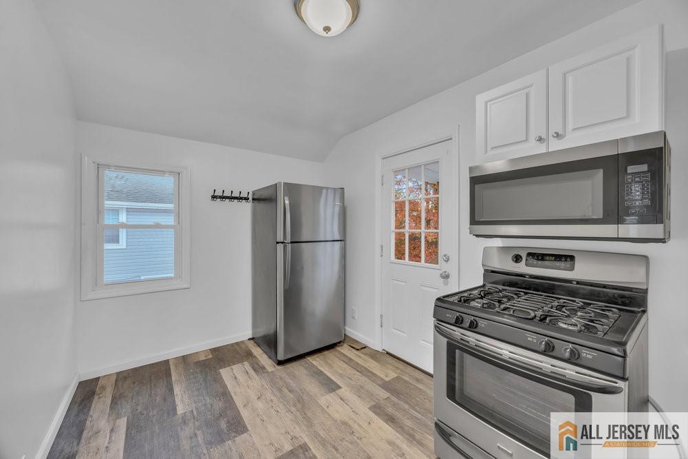 34 Maple Avenue Edison, NJ 08837 - Photo 13 of 20 a kitchen with wooden cabinets and a stove top oven