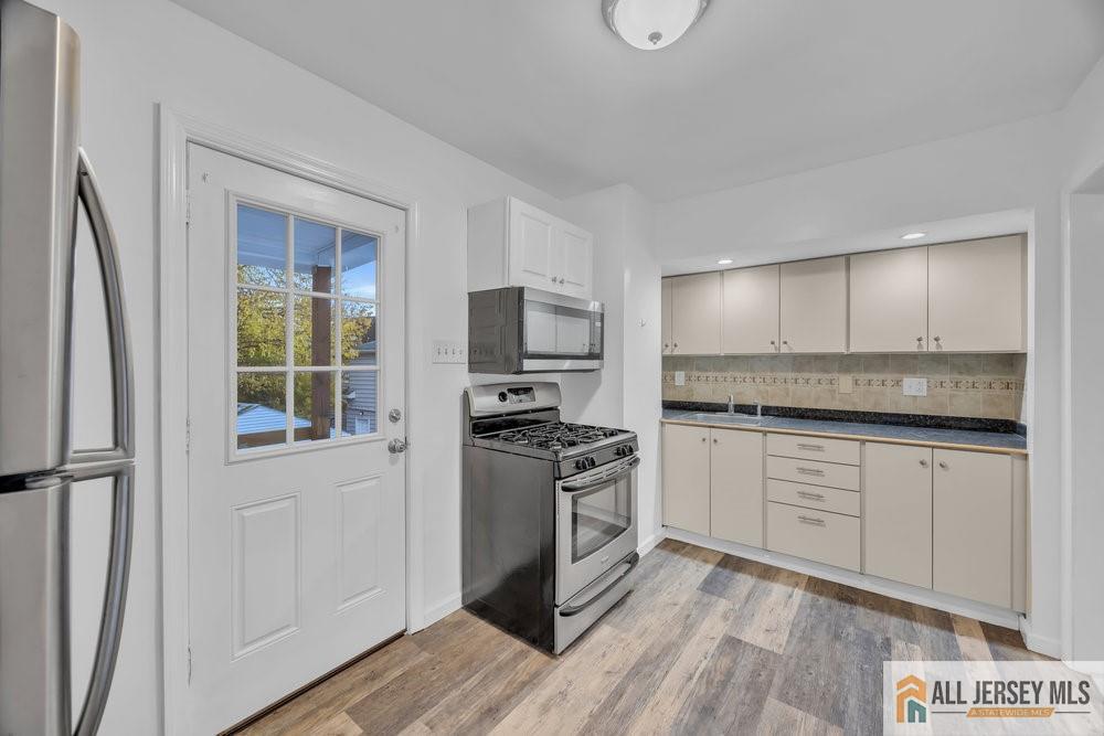 34 Maple Avenue Edison, NJ 08837 - Photo 14 of 20 a kitchen with stainless steel appliances granite countertop a stove and a sink
