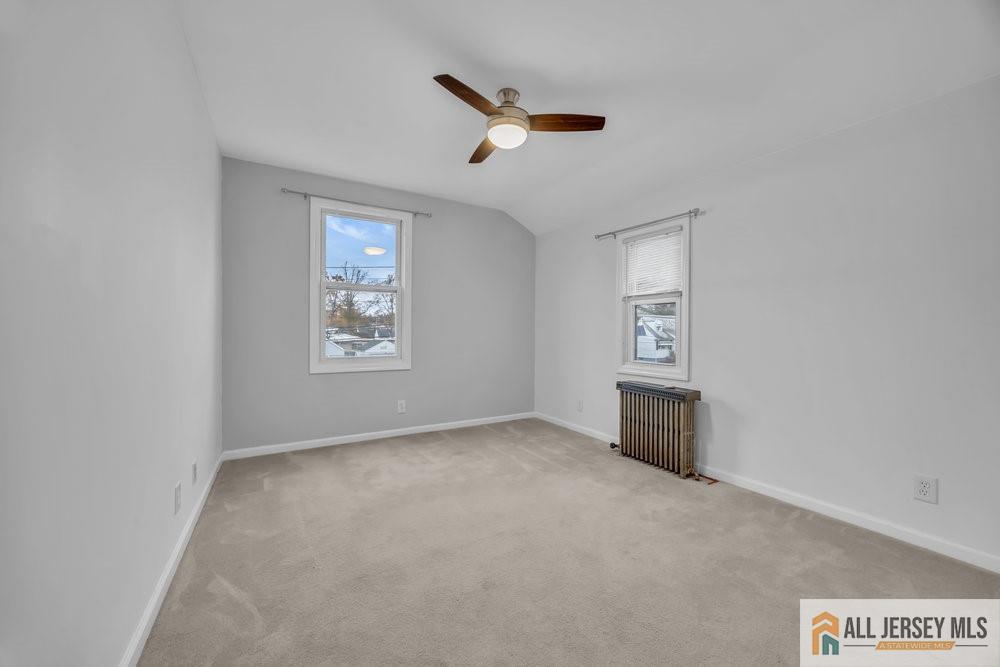 34 Maple Avenue Edison, NJ 08837 - Photo 20 of 20 an empty room with windows and ceiling fan
