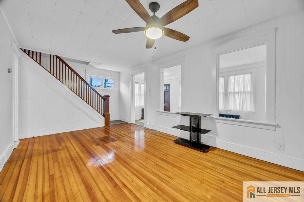 34 Maple Avenue Edison, NJ 08837 - Photo 5 of 20 a view of a livingroom with wooden floor and a ceiling fan