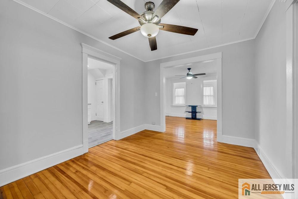 34 Maple Avenue Edison, NJ 08837 - Photo 7 of 20 a view of empty room with wooden floor and fan