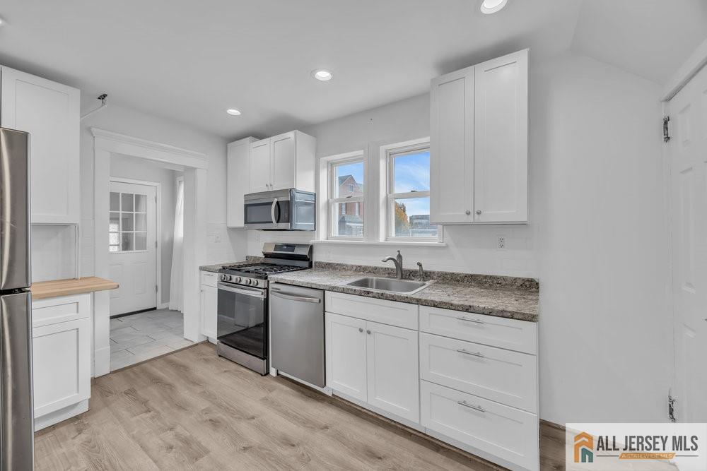 34 Maple Avenue Edison, NJ 08837 - Photo 8 of 20 a kitchen with stainless steel appliances granite countertop a stove a sink and a refrigerator