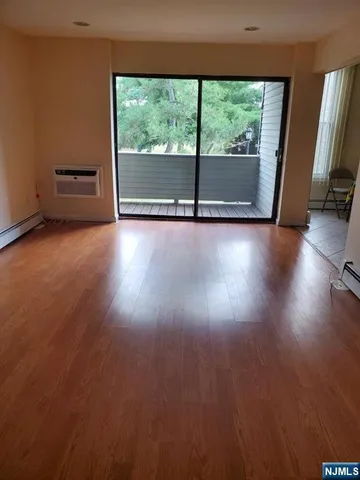 a view of room with window and wooden floor