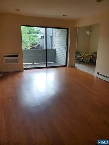 a view of room with window and wooden floor