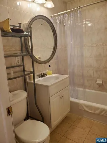 a bathroom with a sink mirror vanity and toilet
