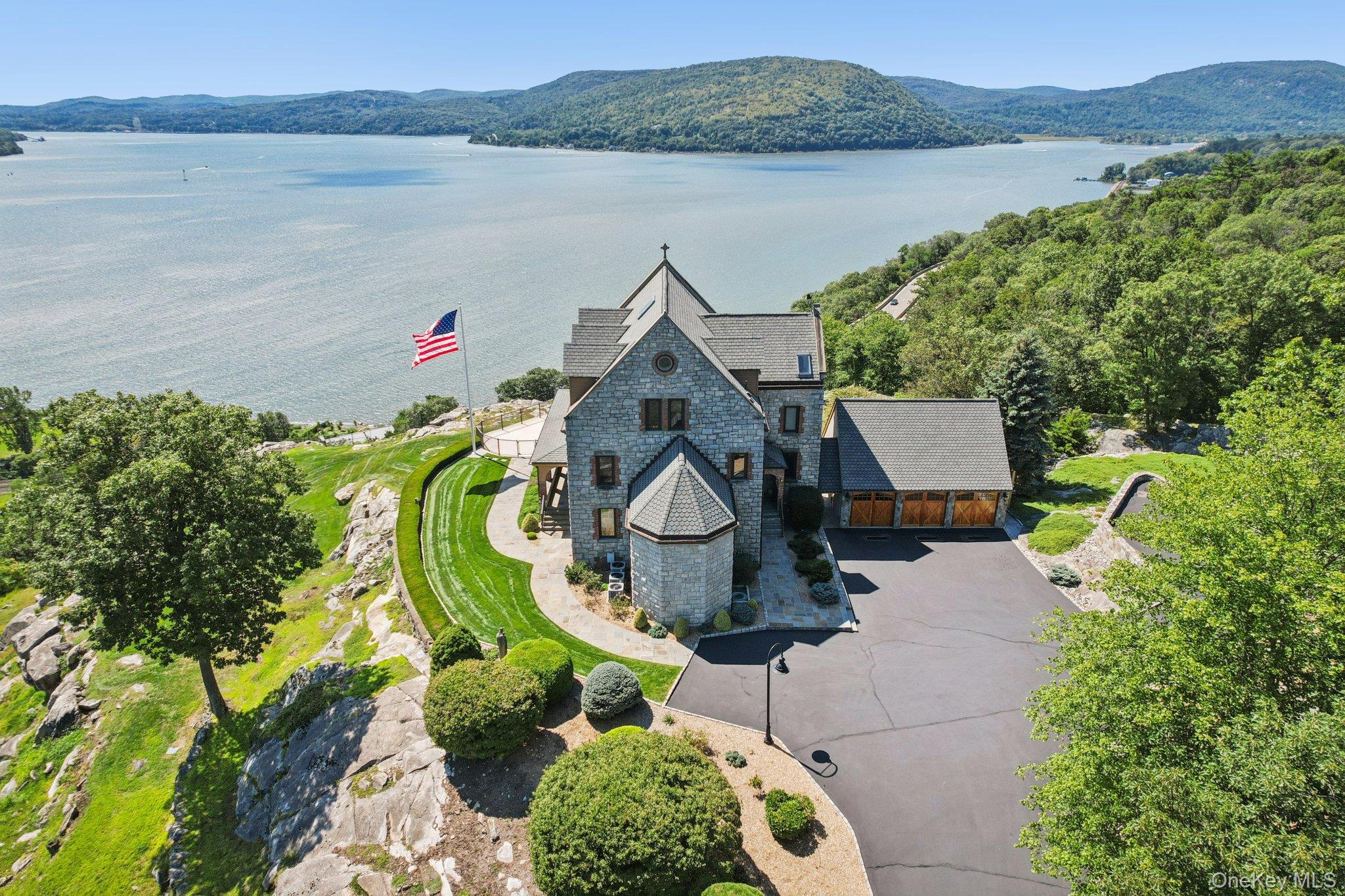 Aerial view of property and surrounding area featuring a water and mountain view
