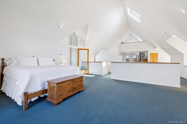 a spacious bedroom with a bed and window