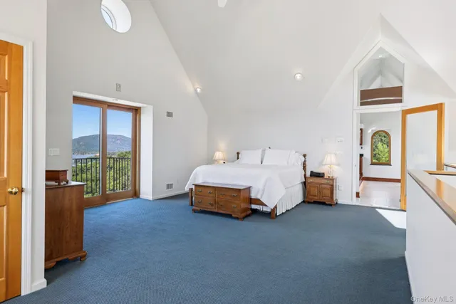 a spacious bedroom with a bed and a window