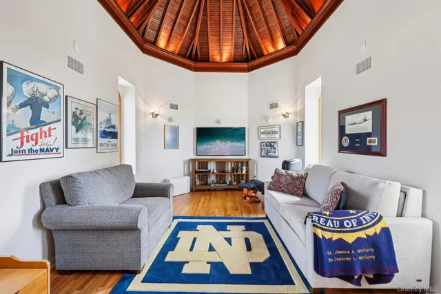 a living room with furniture a rug and a fireplace