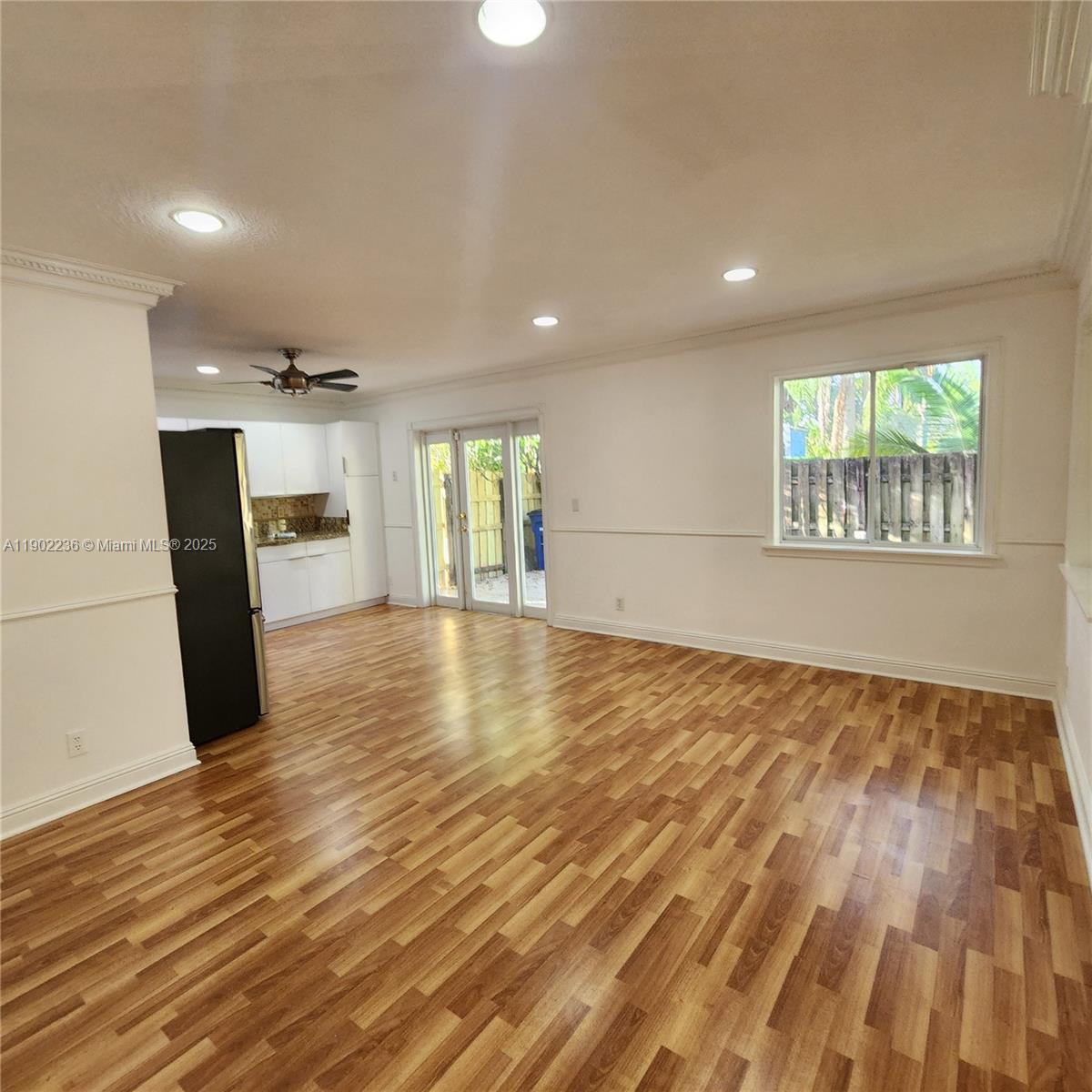 11281 Reveille Road Cooper City, FL 33026 - Photo 11 of 42 an empty room with wooden floor and windows