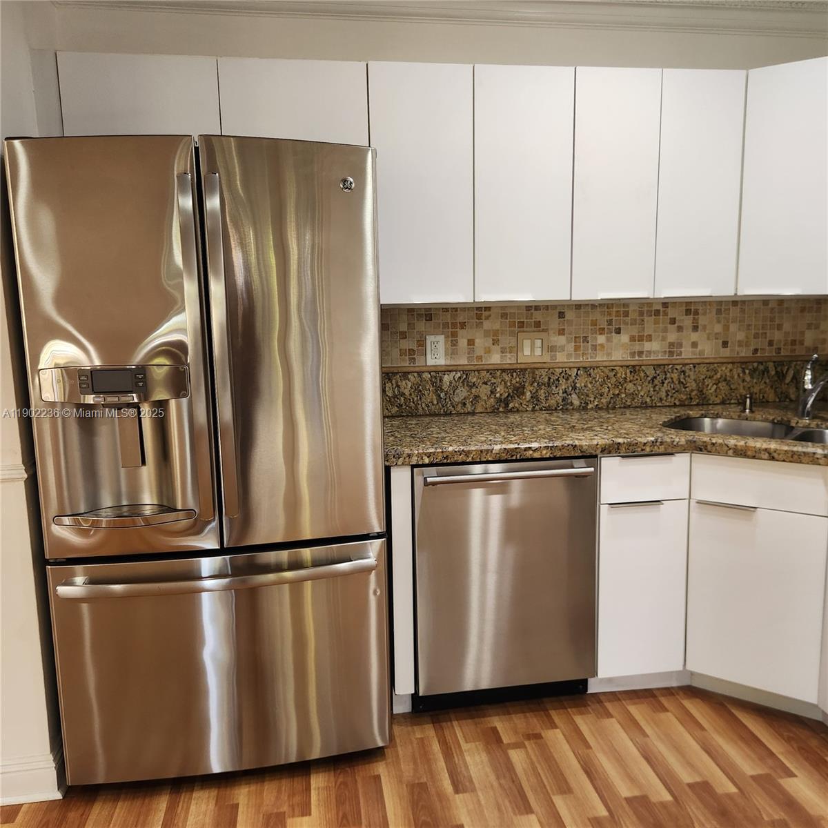 11281 Reveille Road Cooper City, FL 33026 - Photo 13 of 42 a view of a kitchen with wooden floor stainless steel appliances and cabinets