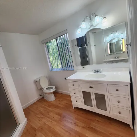 a bathroom with a sink vanity and a mirror