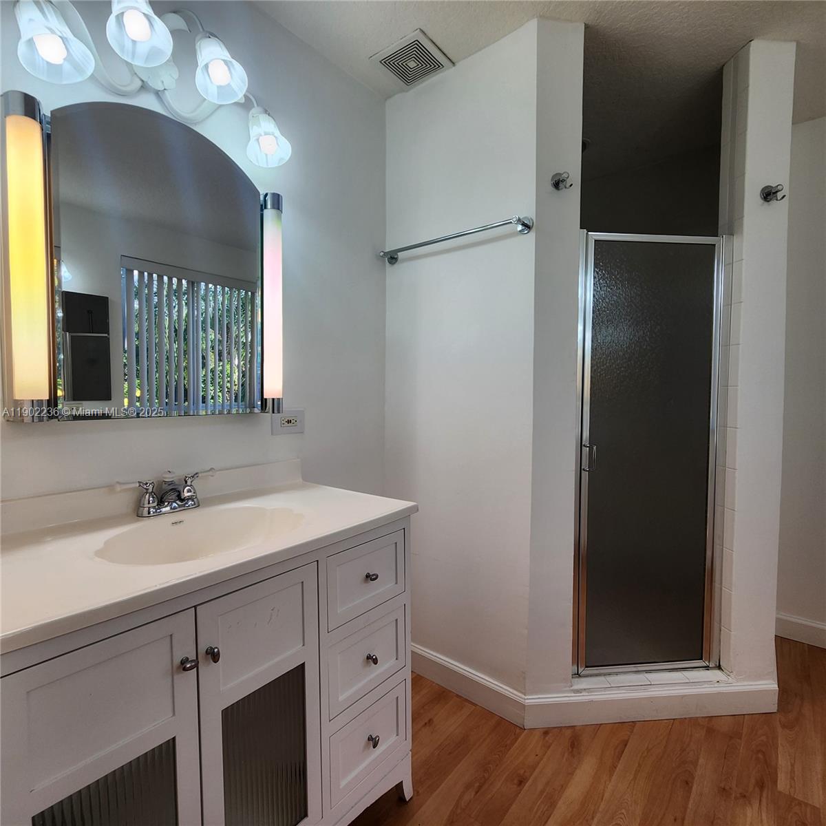 11281 Reveille Road Cooper City, FL 33026 - Photo 20 of 42 a bathroom with a sink and a mirror