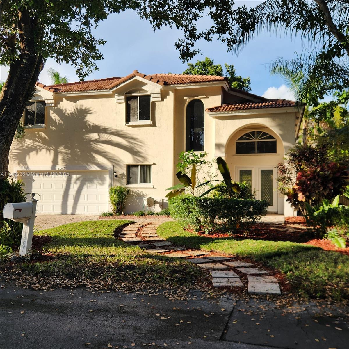 11281 Reveille Road Cooper City, FL 33026 - Photo 2 of 42 a front view of a house with a yard