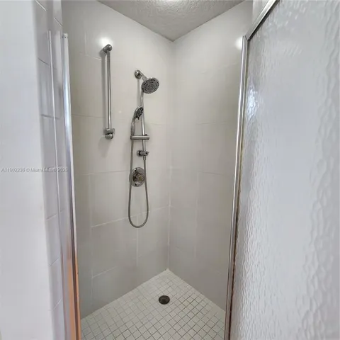 a bathroom with a glass shower door