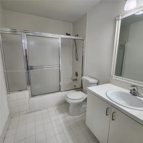 a bathroom with a toilet a sink and a shower