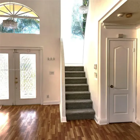a view of a livingroom with wooden floor and a window