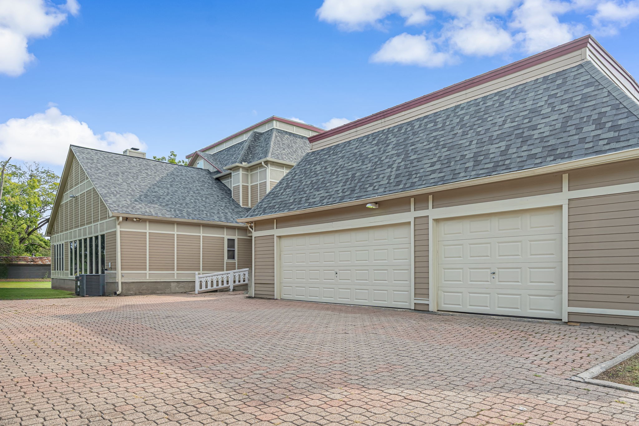 4028 Crosby Cedar Bayou Road Baytown, TX 77521 - Photo 7 of 35 Expansive 3-car garage with brick-paver motor court—seamlessly connected to the home by the wraparound veranda/breezeway and adjacent screened porch.