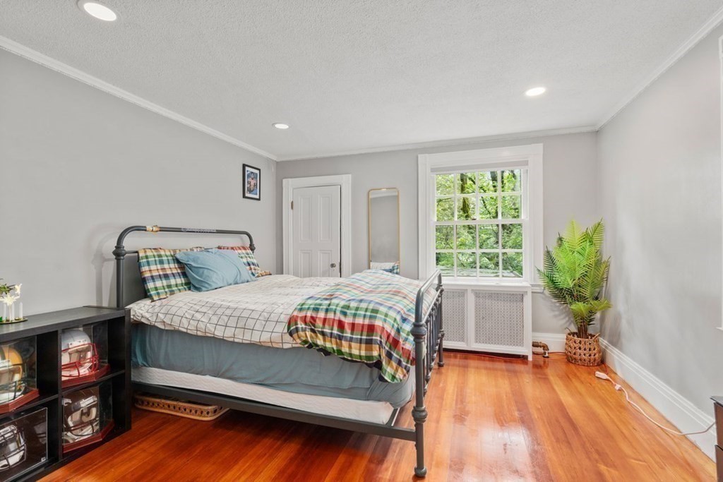 21 Windsor Road Wellesley, MA 02481 - Photo 18 of 28 a bedroom with a bed and a chair