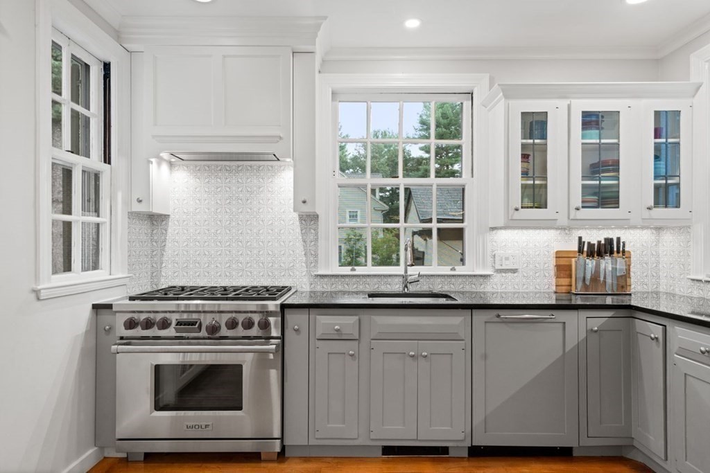 21 Windsor Road Wellesley, MA 02481 - Photo 6 of 28 a kitchen with granite countertop cabinets stainless steel appliances and a sink