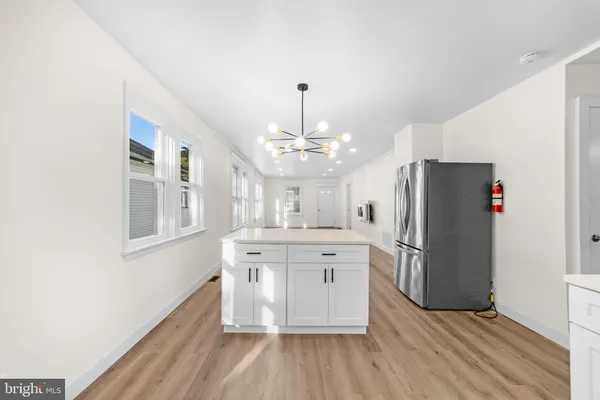 a kitchen with stainless steel appliances a refrigerator and a stove top oven