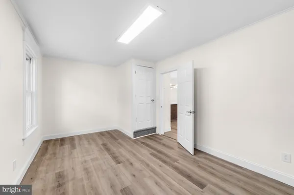 a view of room with wooden floor