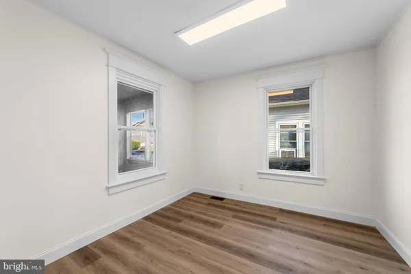 an empty room with windows and closet