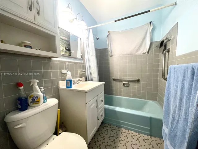 a bathroom with a sink toilet vanity and shower