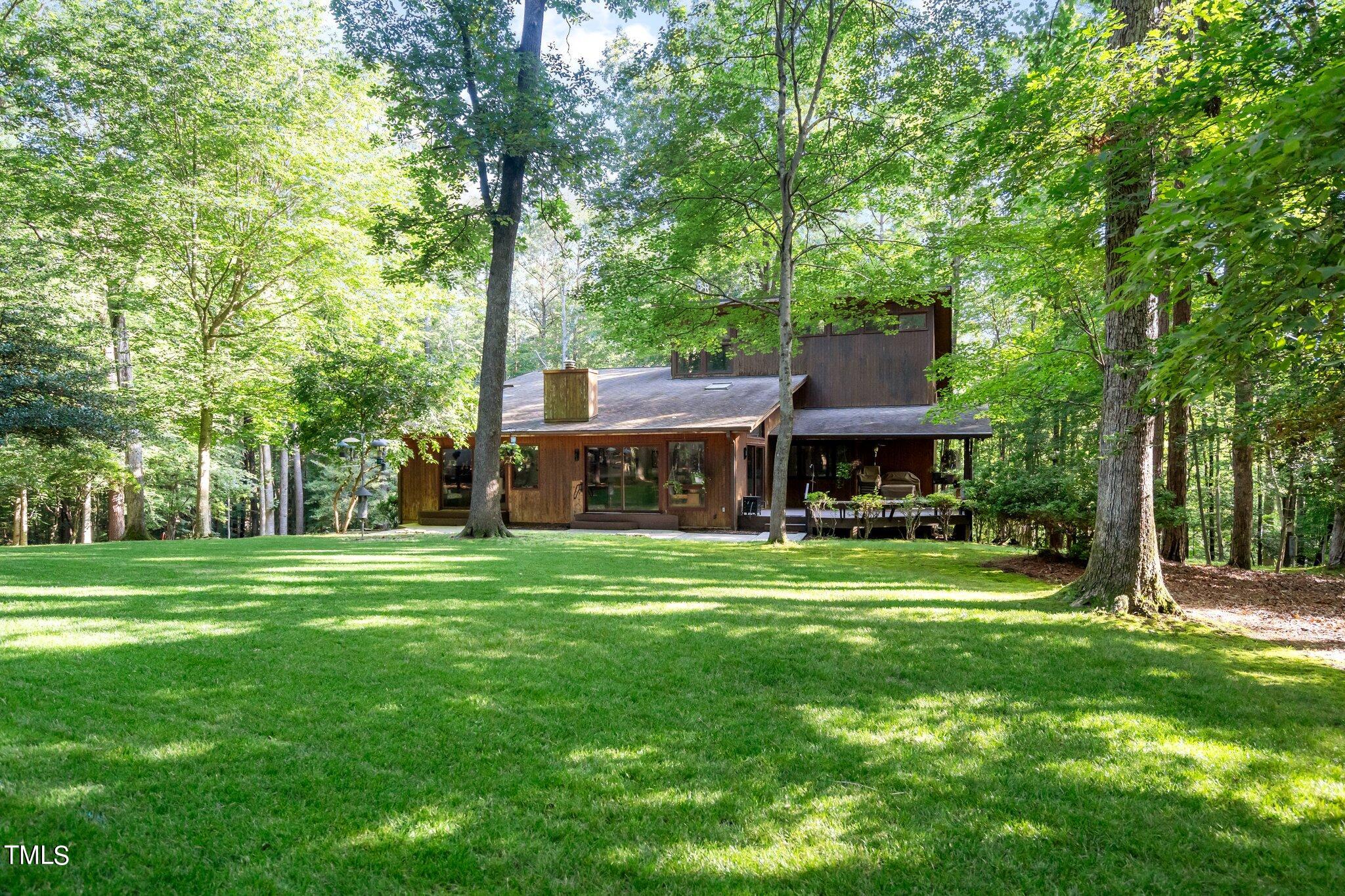 12012 Peed Road Raleigh, NC 27614 - Photo 5 of 48 a view of a big house with a big yard and large trees
