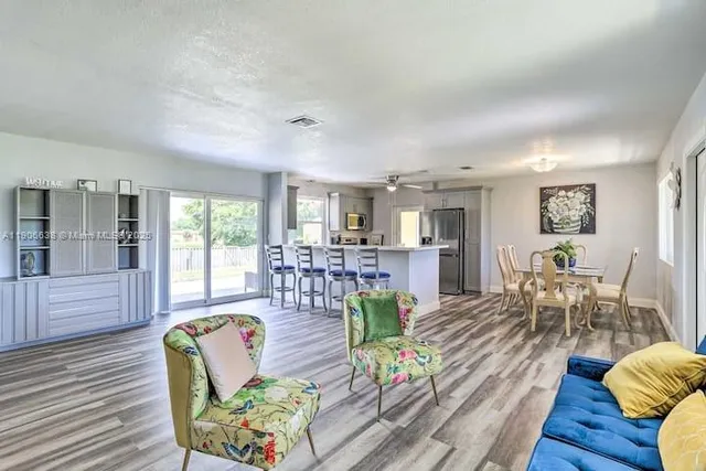 a living room with furniture and wooden floor