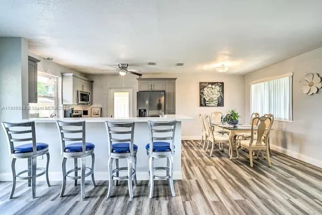 a view of a dining room with furniture and wooden floor