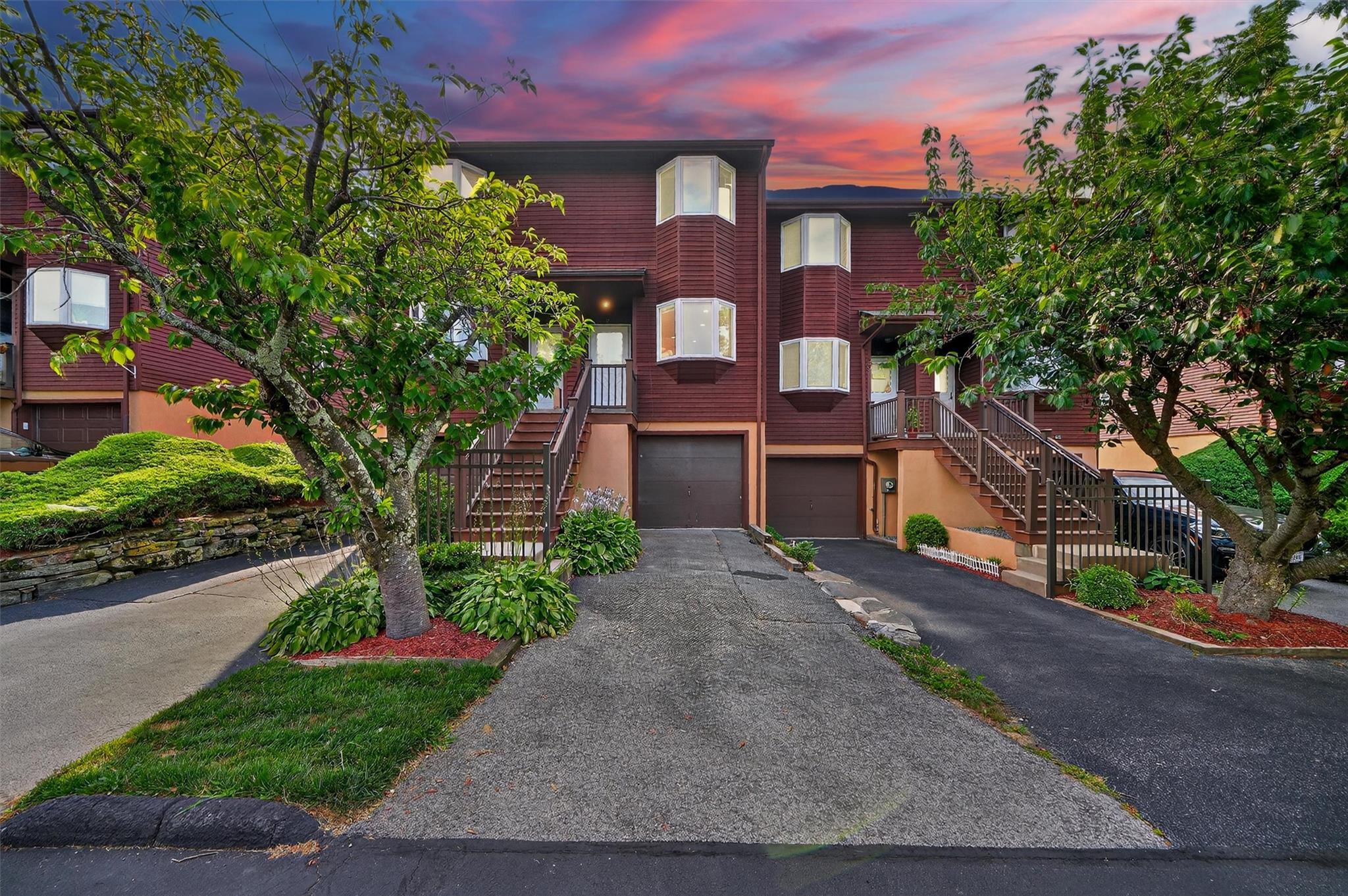 a front view of a house with a yard and a garage