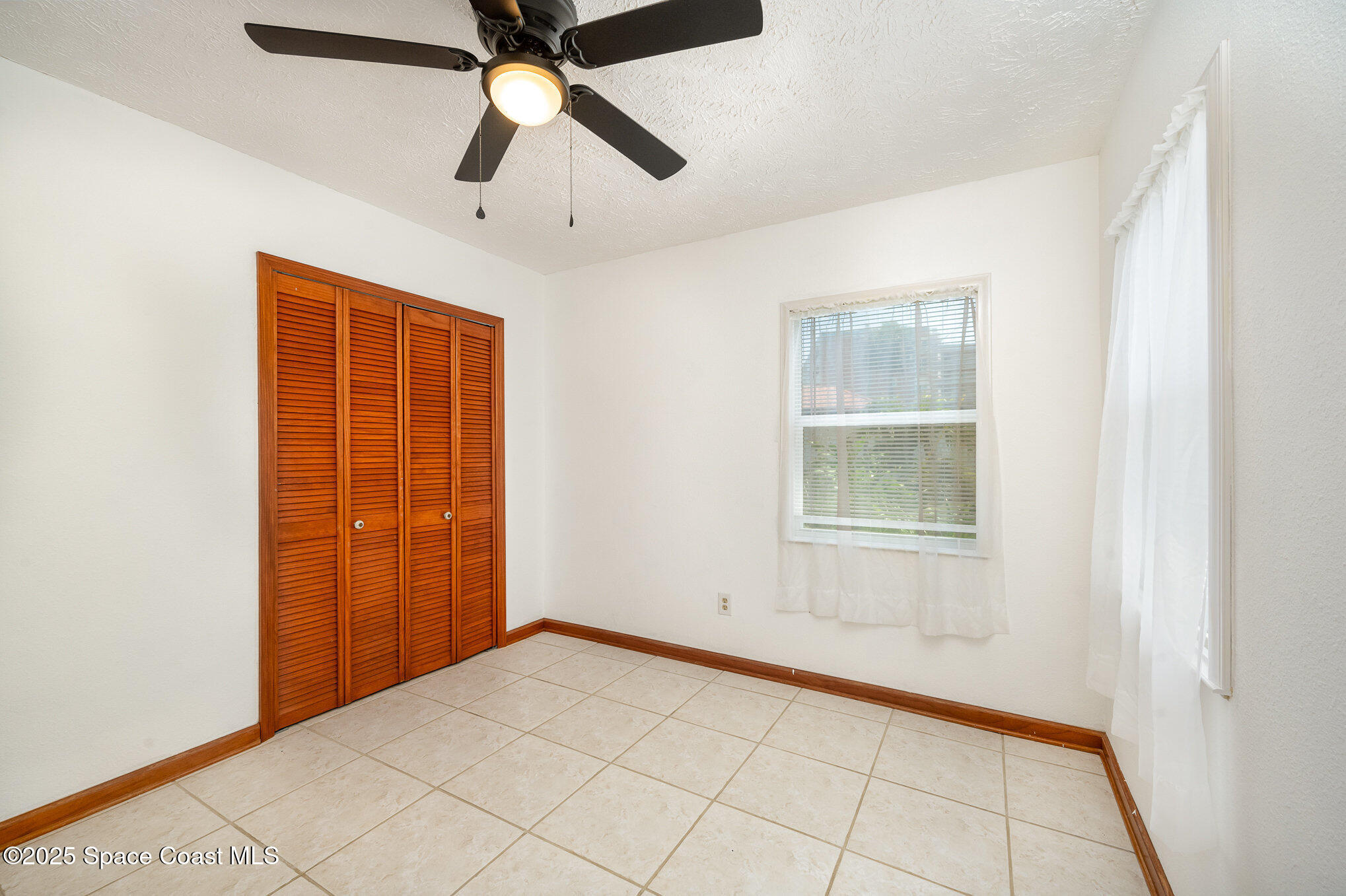 121 Del Flora Indialantic, FL 32903 - Photo 2 of 15 an empty room with windows and fan