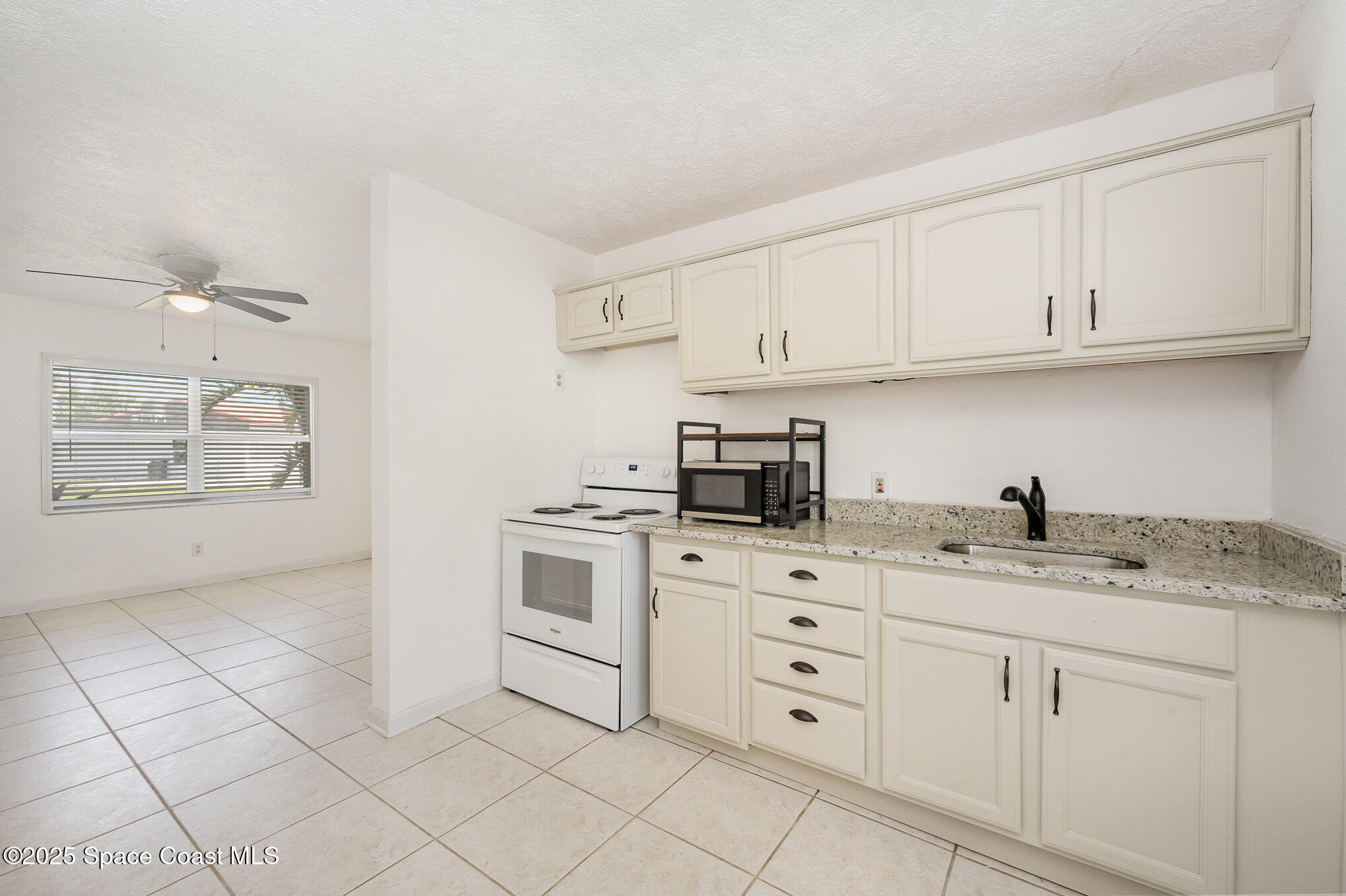 121 Del Flora Indialantic, FL 32903 - Photo 6 of 15 a kitchen with granite countertop a sink and cabinets