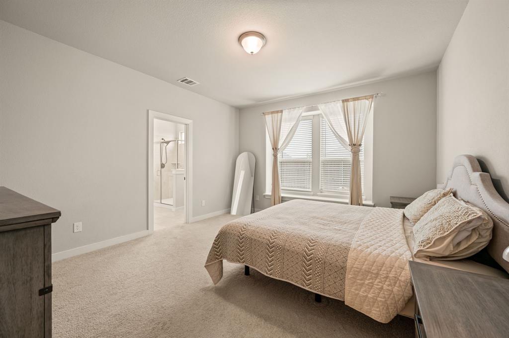 417 Ardsley Lane Forney, TX 75126 - Photo 12 of 31 a bedroom with a bed and a large window