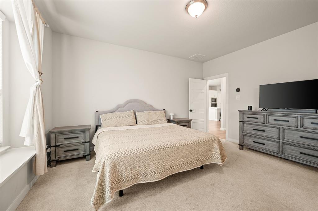 417 Ardsley Lane Forney, TX 75126 - Photo 13 of 31 a bedroom with a bed and a flat screen tv