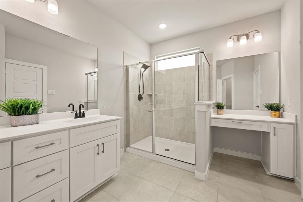 417 Ardsley Lane Forney, TX 75126 - Photo 14 of 31 a bathroom with a shower sink and mirror