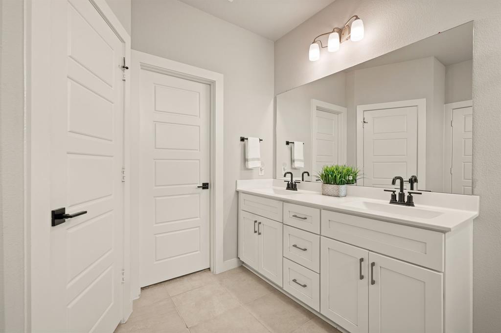 417 Ardsley Lane Forney, TX 75126 - Photo 15 of 31 a bathroom with a double vanity sink and mirror
