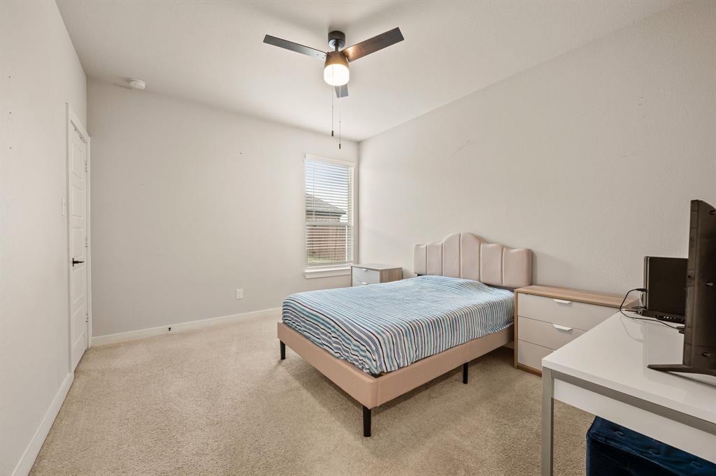 417 Ardsley Lane Forney, TX 75126 - Photo 17 of 31 a bedroom with a bed and a table in it