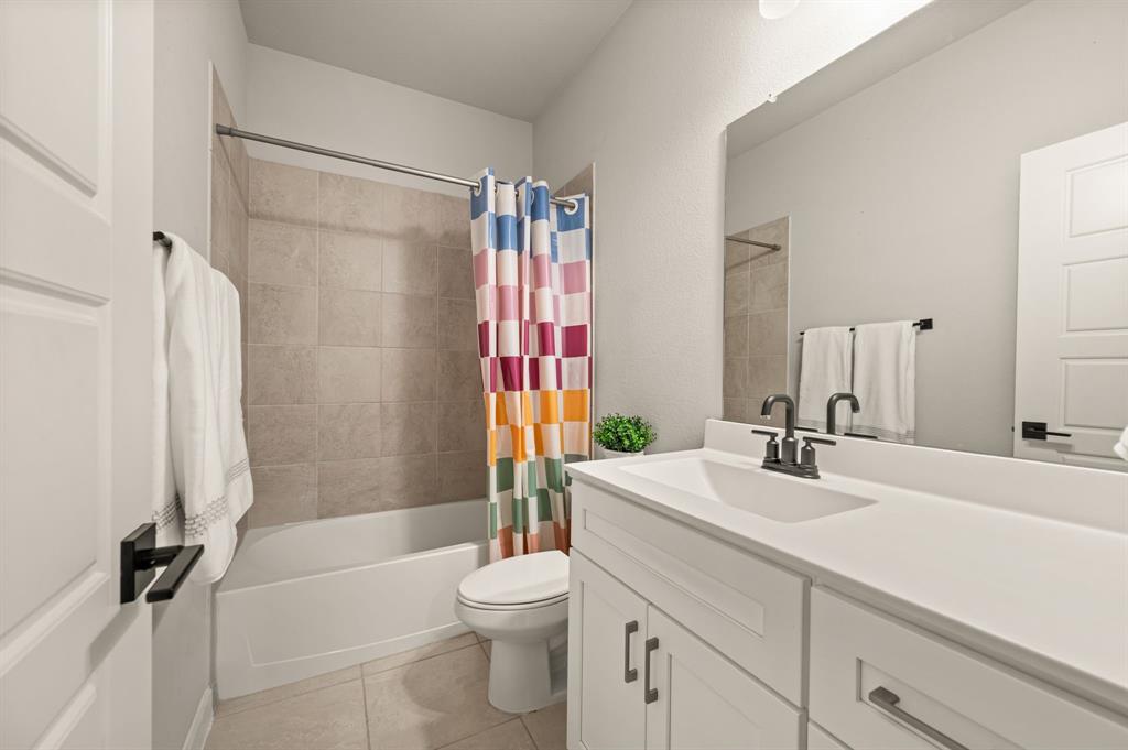 417 Ardsley Lane Forney, TX 75126 - Photo 18 of 31 a bathroom with a sink a toilet and shower