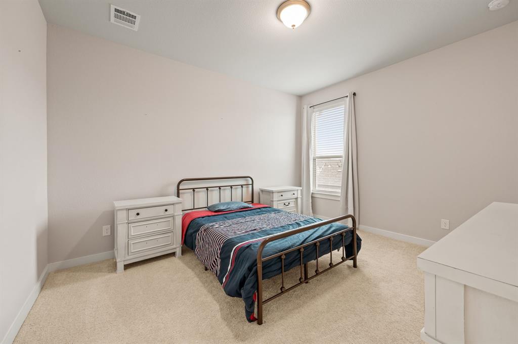 417 Ardsley Lane Forney, TX 75126 - Photo 21 of 31 a bedroom with a bed and a window