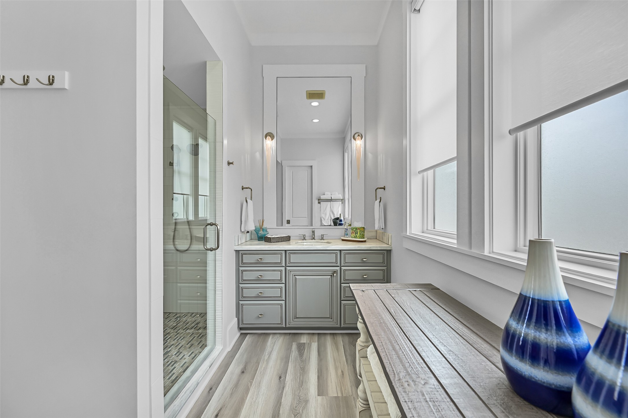 817 Positano Road Galveston, TX 77550 - Photo 29 of 50 This private ensuite bathroom features a spacious vanity, abundant storage, and a glass-enclosed shower for added comfort and convenience. Thoughtfully designed with extended stays in mind, it provides guests with their own well-appointed retreat.