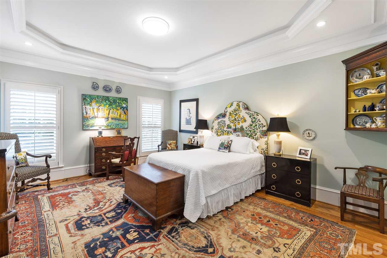 1907 McCarthy Street Raleigh, NC 27608 - Photo 17 of 30 a spacious bedroom with a bed and wooden floor
