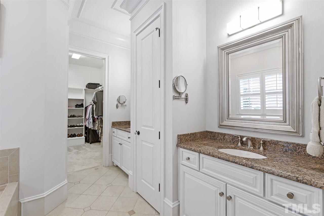 1907 McCarthy Street Raleigh, NC 27608 - Photo 19 of 30 a bathroom with a granite countertop sink and a mirror