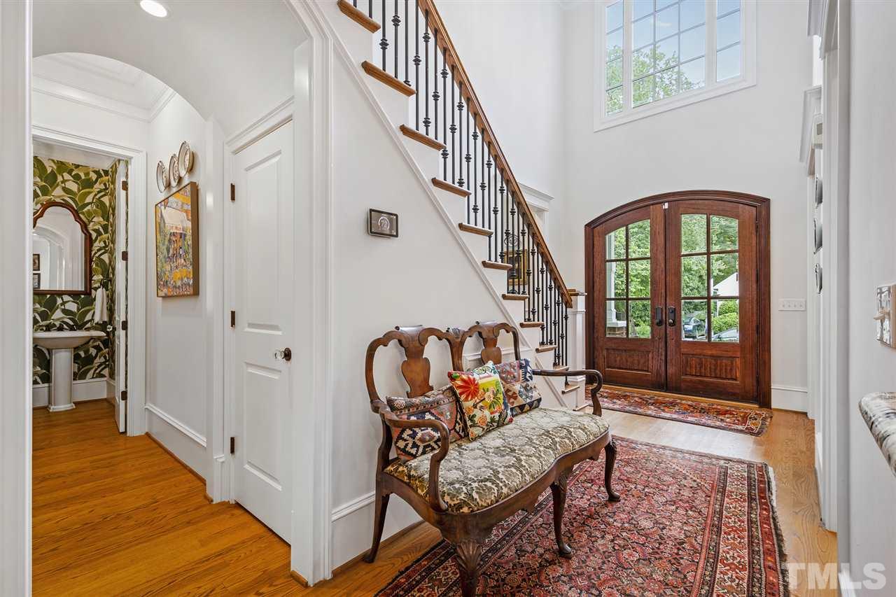 1907 McCarthy Street Raleigh, NC 27608 - Photo 3 of 30 a view of a hallway with wooden floor and stairs