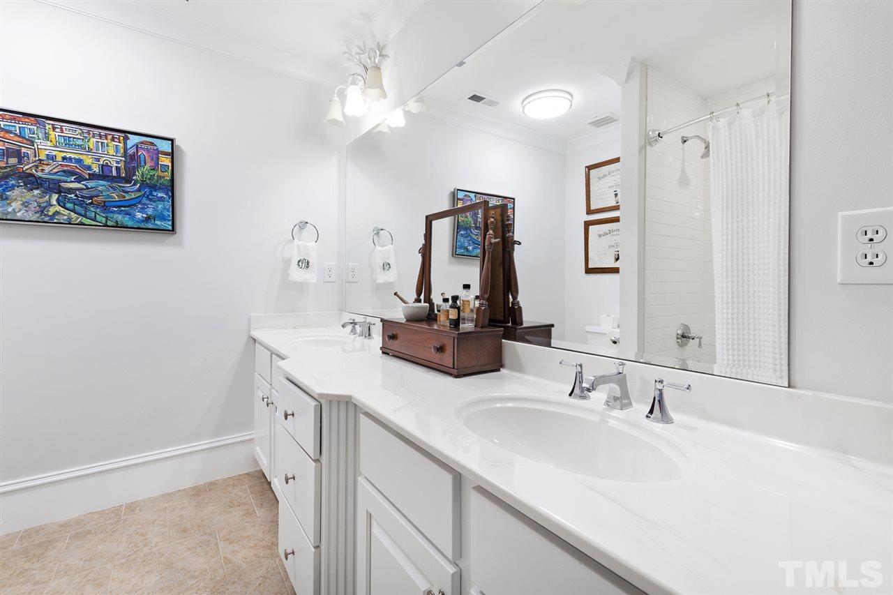 1907 McCarthy Street Raleigh, NC 27608 - Photo 24 of 30 a bathroom with a double vanity sink and a mirror