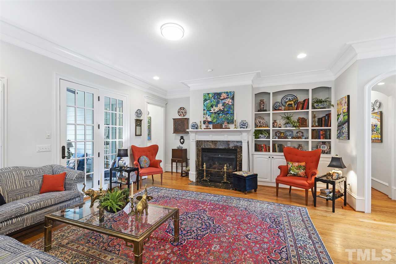 1907 McCarthy Street Raleigh, NC 27608 - Photo 8 of 30 a living room with furniture a rug and a fireplace